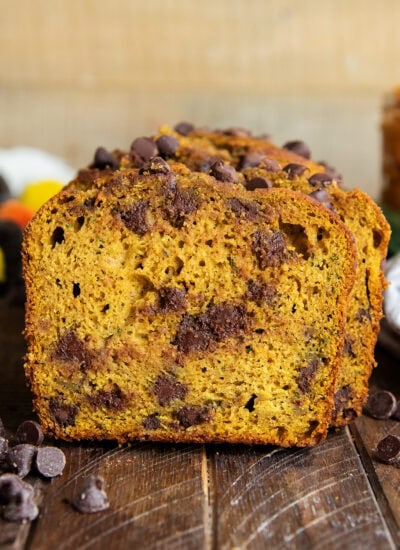 A close up of a piece of chocolate chip pumpkin zucchini bread.