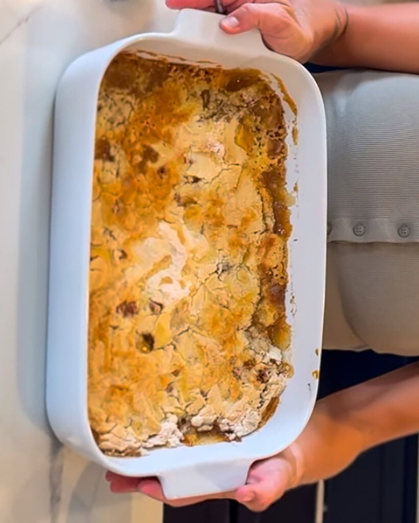 A pan of apple dump cake with a cake mix in a pan.