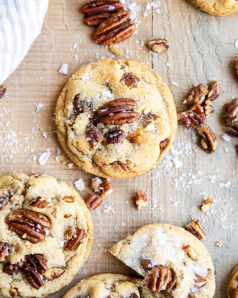 An above view of buttered pecan cookies with pecans on top.