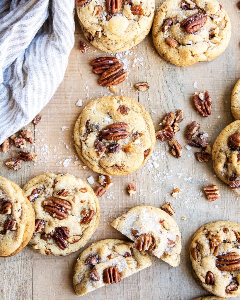 An above view of buttered pecan cookies with pecans on top.