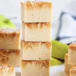 A stack of four pieces of caramel apple fudge, with caramel swirled in the top.