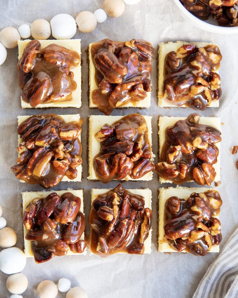 An above view of three rows of pecan pie cheesecake bars.