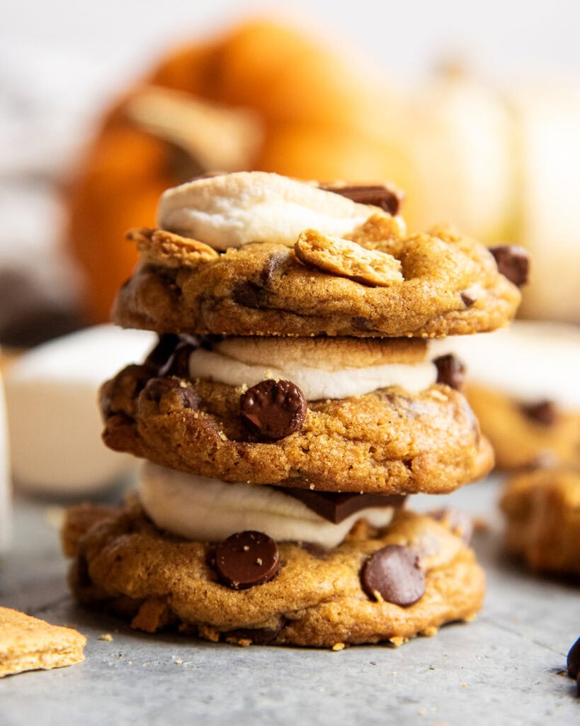 A stack of three pumpkin chocolate chip marshmallow cookies.