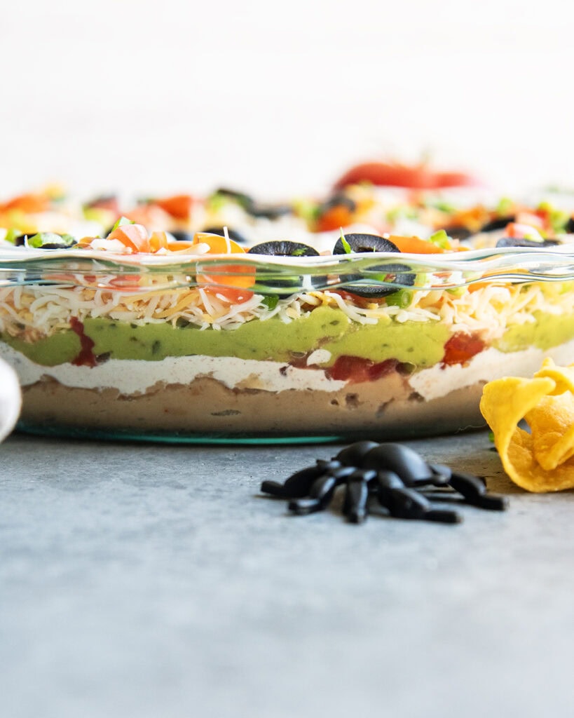 A side view of a glass dish with seven layer dip.