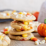 A stack of cookies loaded with white chocolate and candy corn pieces.