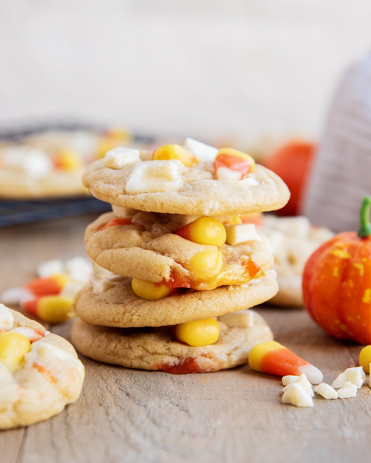 A stack of cookies loaded with white chocolate and candy corn pieces.
