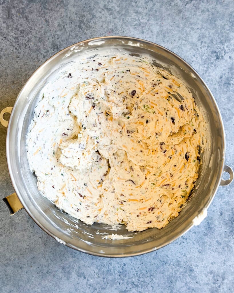 Cheeseball mixture in a big metal bowl.