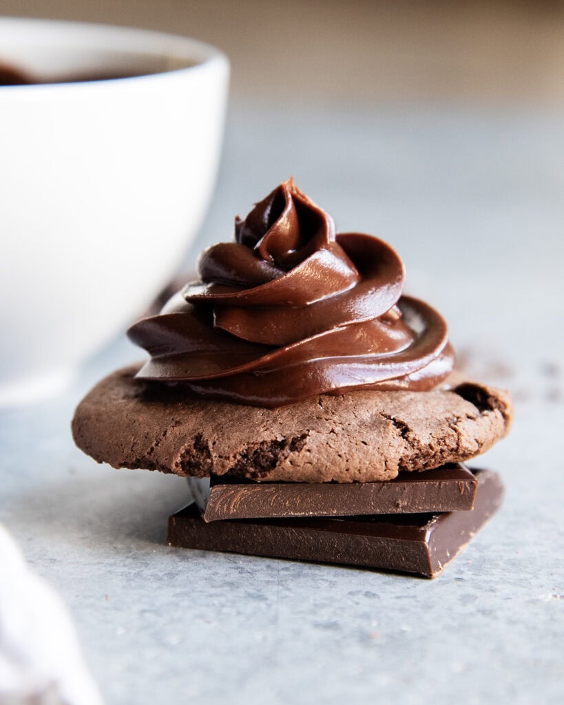 Fudgy chocolate ganache piped on a cookie.