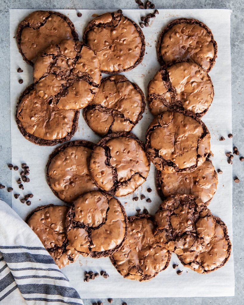 An above view of flourless chocolate cookies on a piece of parchment paper.