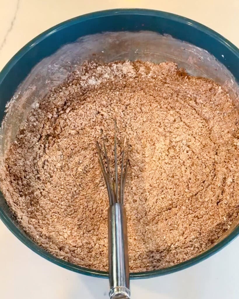 Powdered sugar and cocoa powder whisked together in a bowl.