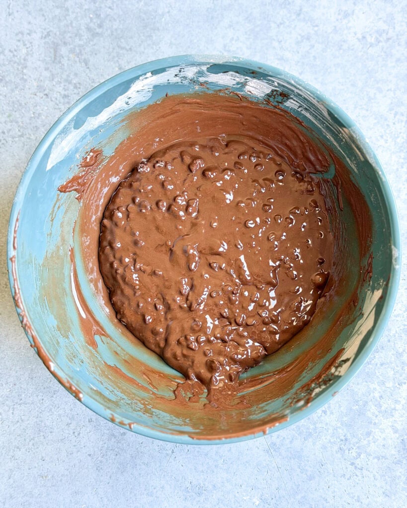 The batter for flourless chocolate cookies in a teal bowl.