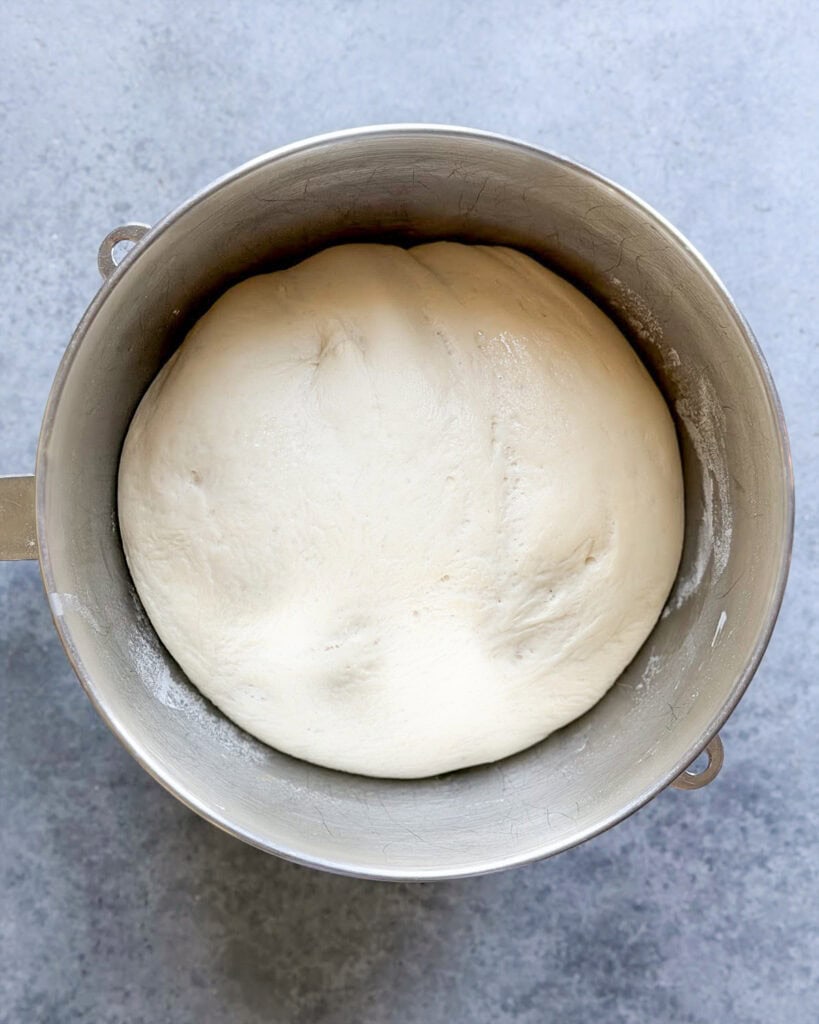 Homemade bagel dough that has risen in a bowl.