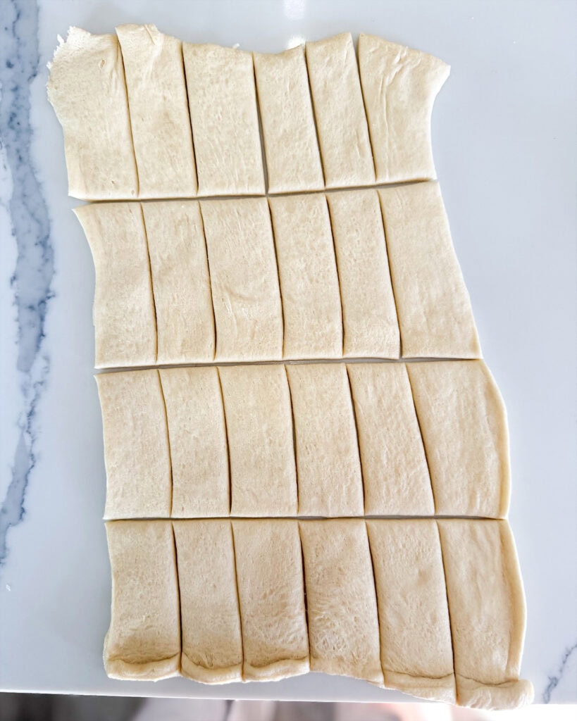 Crescent roll dough sliced into 24 pieces.
