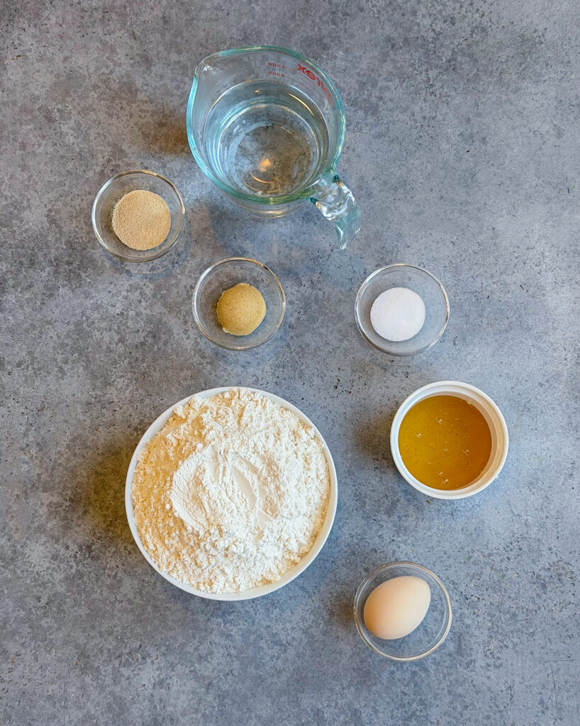 Small bowls of the ingredients needed to make homemade bagels. 