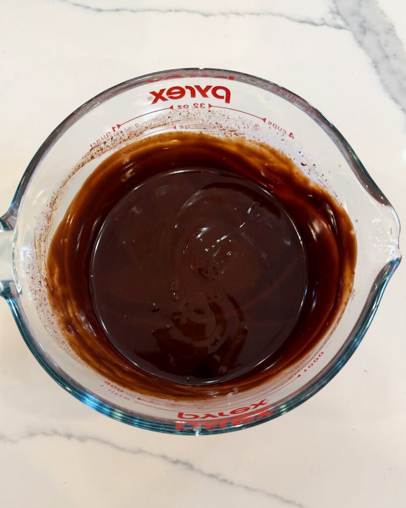 Melted chocolate in a glass bowl.