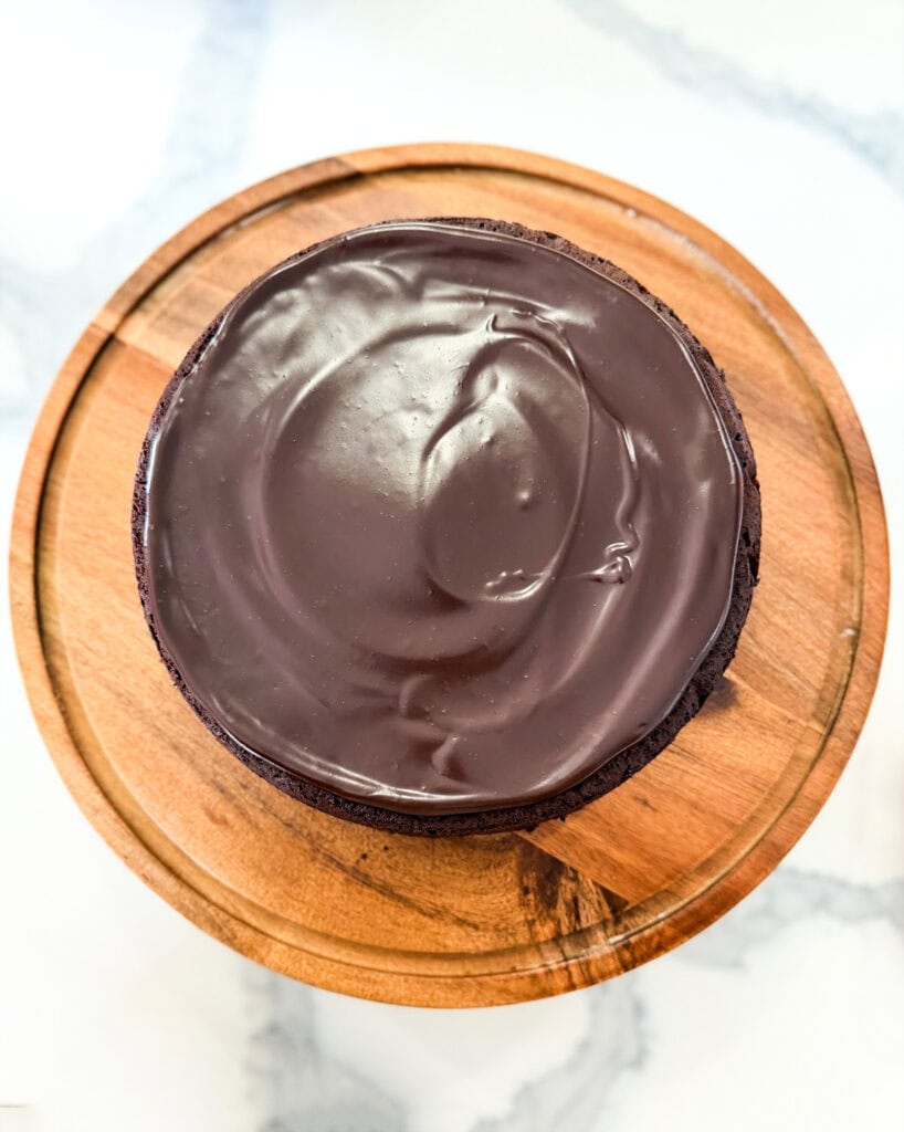 A ganache topped flourless chocolate cake.
