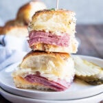 A stack of two Reuben Corned Beef Sliders on a plate.