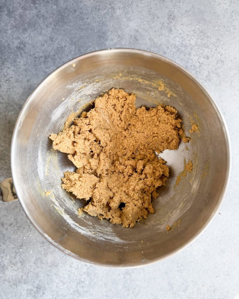 Graham cracker cookie dough in a metal bowl.
