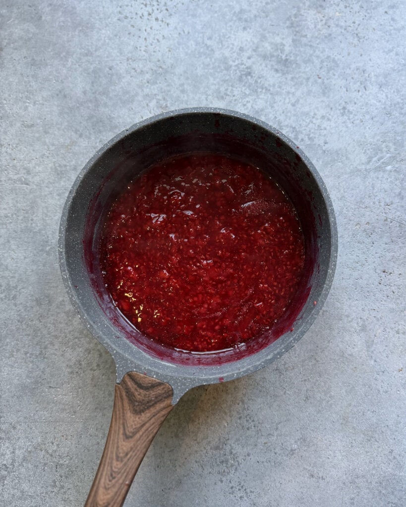 Raspberry sauce in a small pot. 