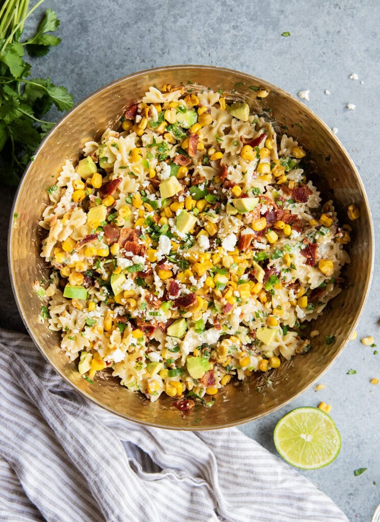 An above view of a bowl of Mexican Street Corn Pasta salad with a creamy chipotle dressing, corn, bacon, cilantro, and jalapenos.