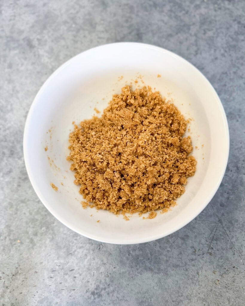 A graham cracker crumble in a bowl.