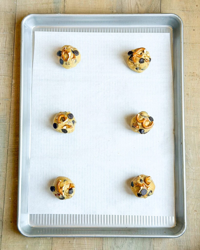 Peanut Butter Pretzel Cookie Dough balls on a cookie sheet.