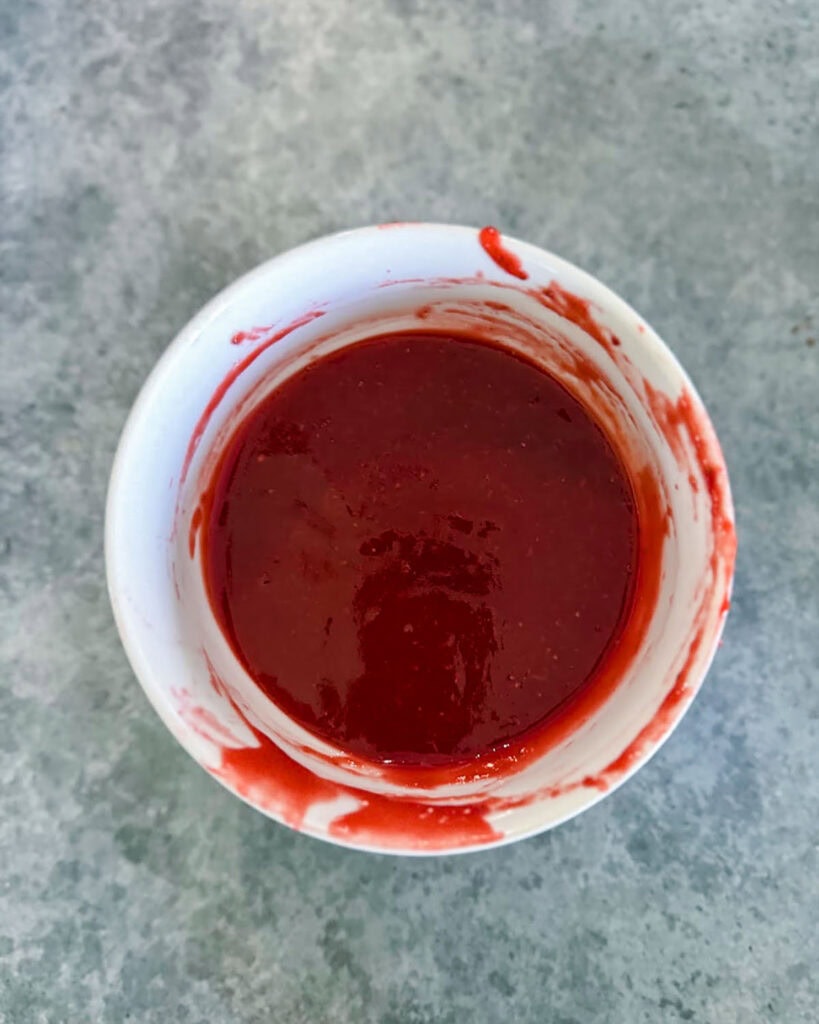 A small bowl of homemade strawberry sauce.