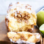 A slice of apple fritter bread on a wooden tray.
