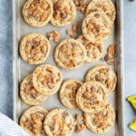 An above view of peanut butter butterfinger cookies on a cookie sheet.
