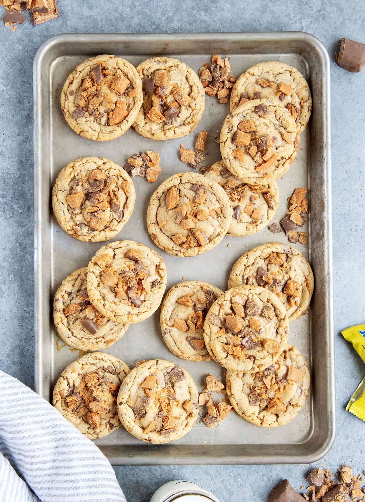 An above view of peanut butter butterfinger cookies on a cookie sheet.