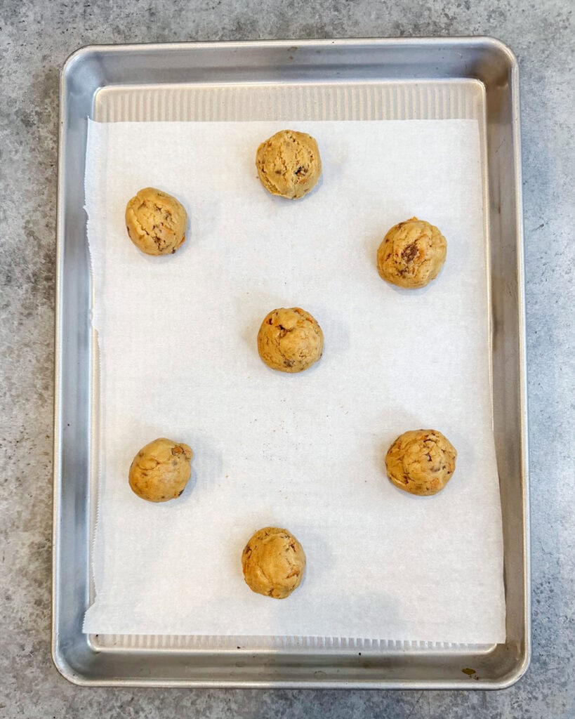 Peanut Butter Butterfinger Cookie Dough balls on a cookie sheet.