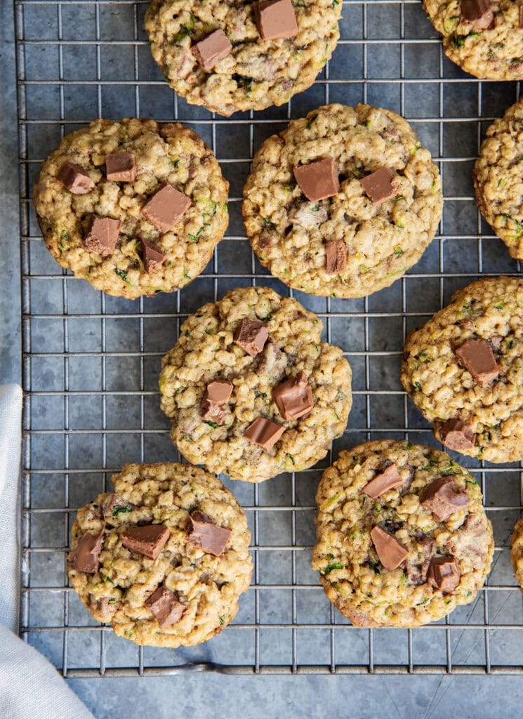 An above view of chocolate chip zucchini cookies on a wire cooling rack.