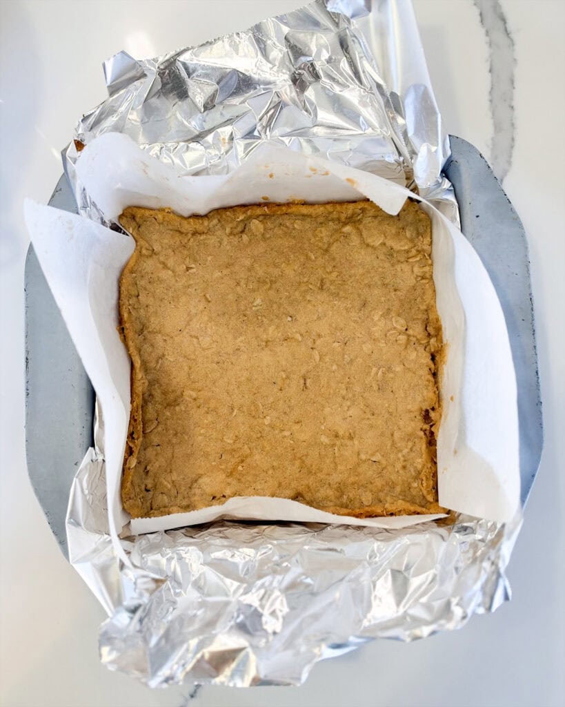 Oatmeal cookie baked in a square pan.