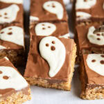 A scotcheroo topped with chocolate and a white chocolate ghost.