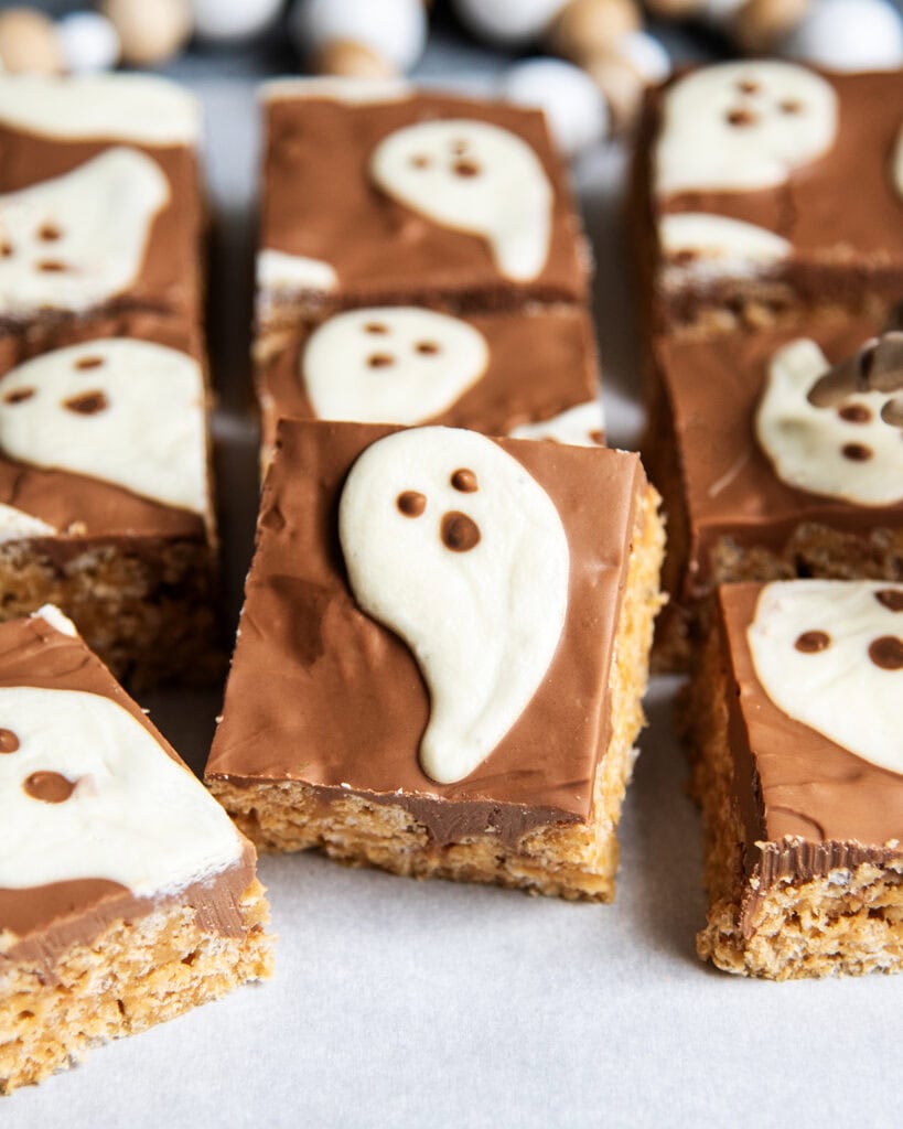 A scotcheroo topped with chocolate and a white chocolate ghost.