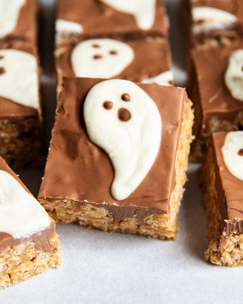 A scotcheroo topped with chocolate and a white chocolate ghost.