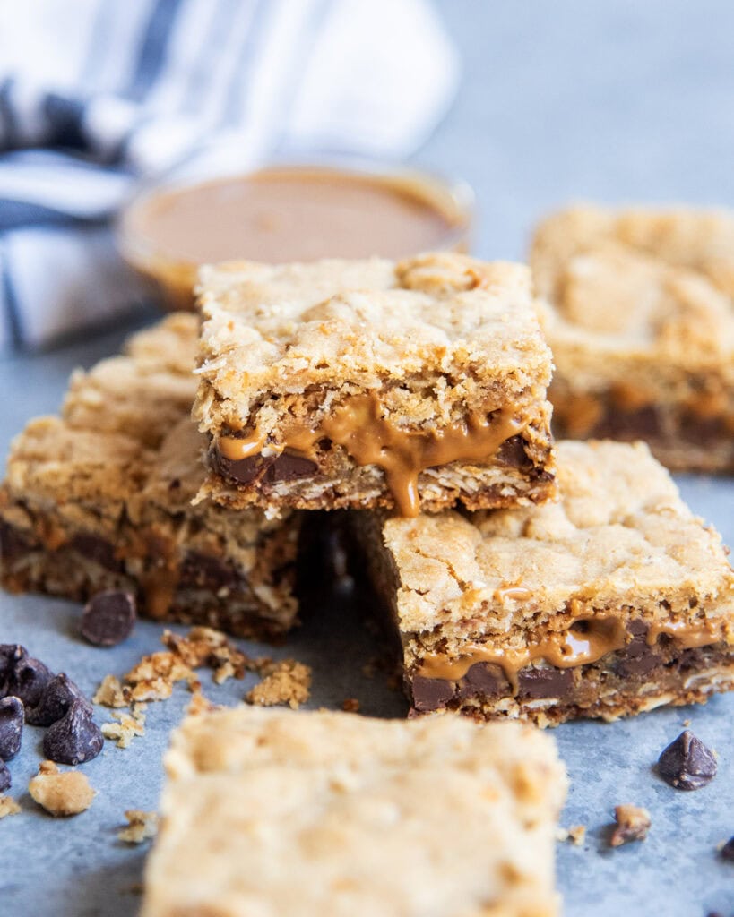 A pile of cookie butter cookie bars with gooey cookie butter coming out of the bars.