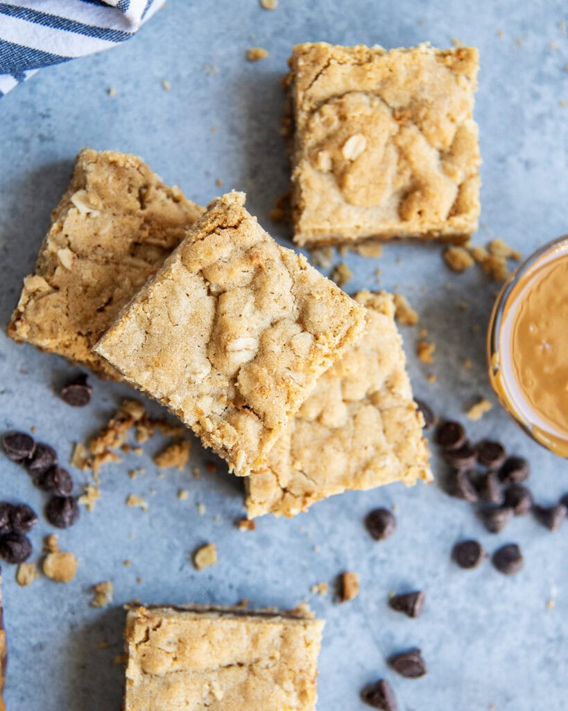 An overhead view of a few oatmeal cookie butter bars stacked in a pile.